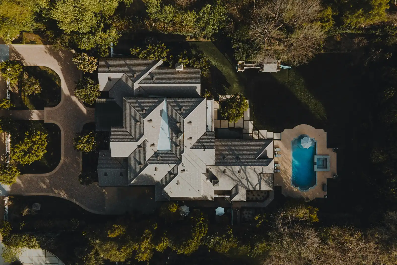 An aerial view of a detached house and the streets around it, for property management in Brampton