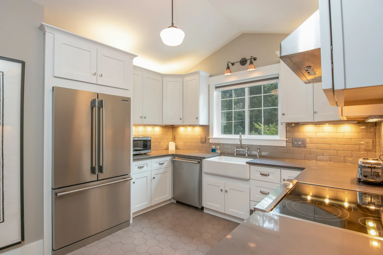 A bright rental kitchen with white cabinets and stainless appliances, for condo property management in Brampton
